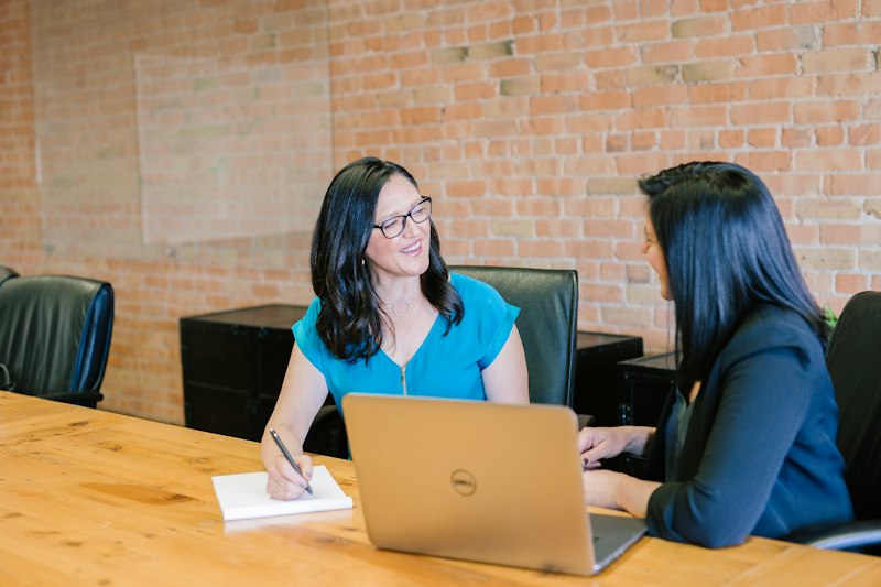 An advisor meeting with a client at a table